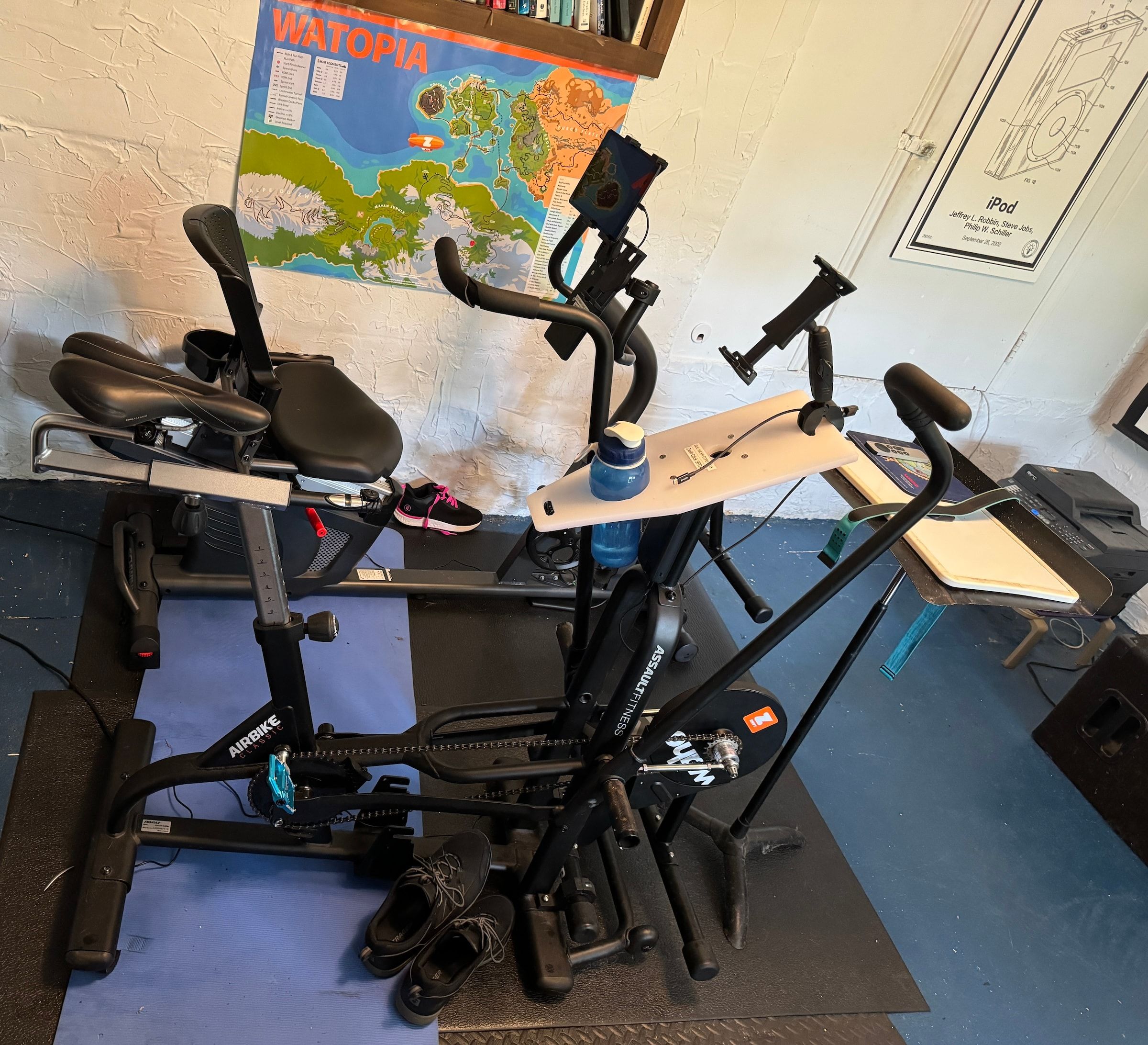 An Assault AirBike conversion and a recumbent FrankenTrainer together in James Terrell's workshop