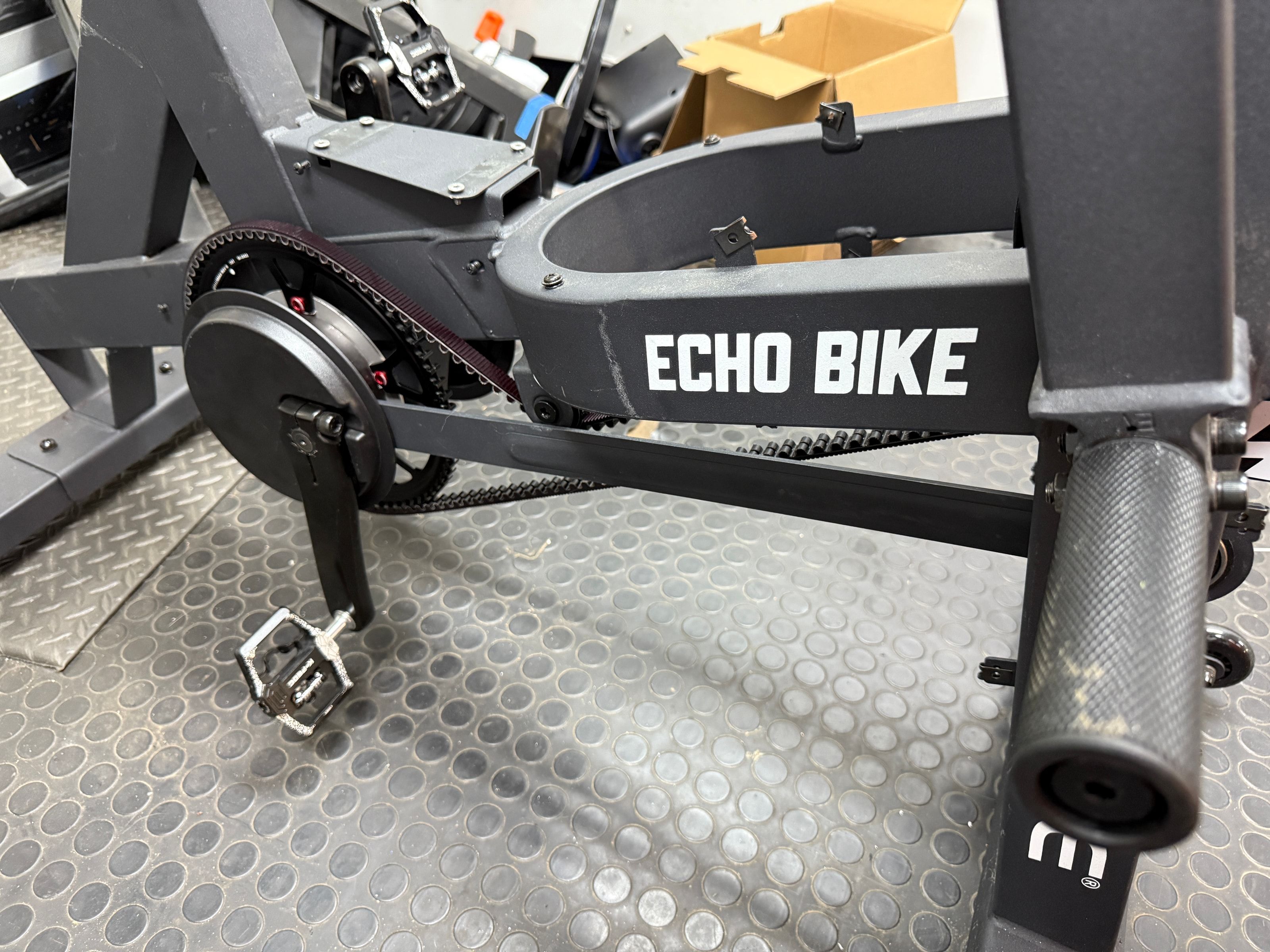 Close side view of a Rogue Echo Bike fitted with a toothed Gates belt and Wahoo smart trainer