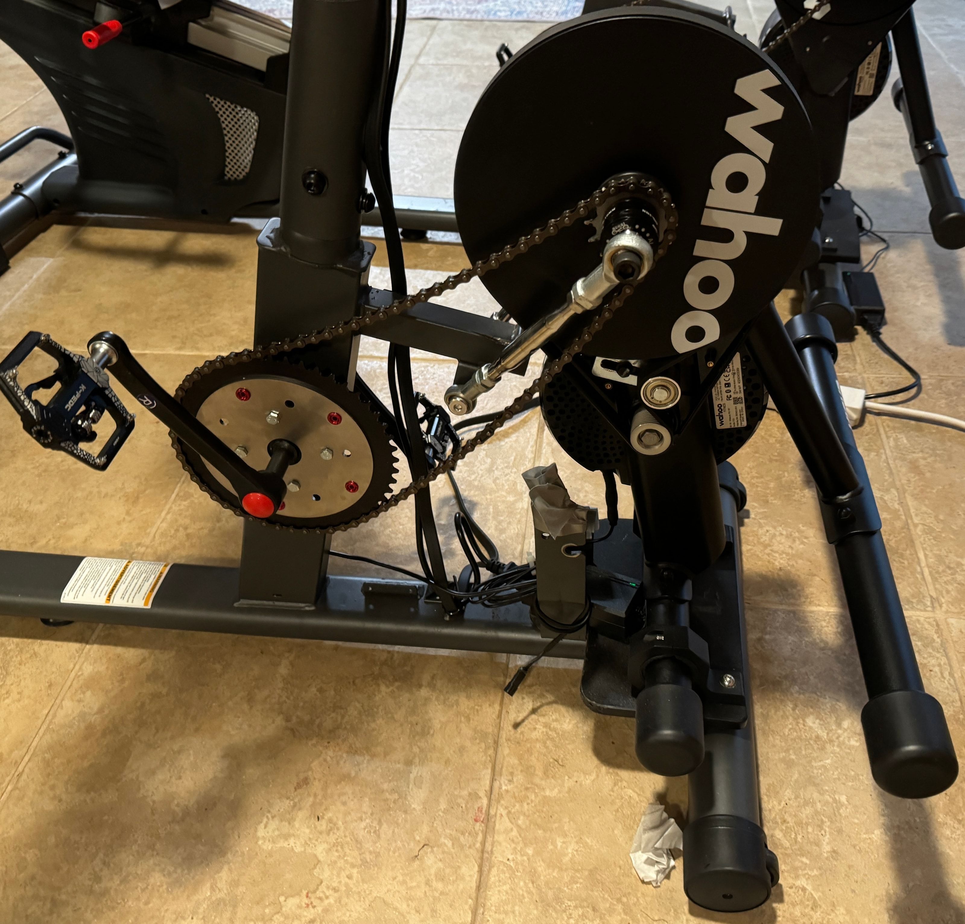 Close view of a Schwinn 270 crank, chainring adapter, chain, and Wahoo smart trainer